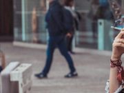 Grand Rapids Latest City In Michigan To Ban Vapes In Parks & Public Places woman smoking in the street