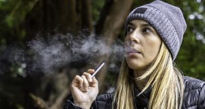 young woman vaping juul