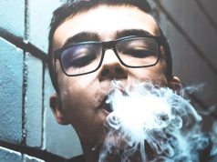 Minnesota Students Still Vaping Despite Mitigation Efforts young man vaping