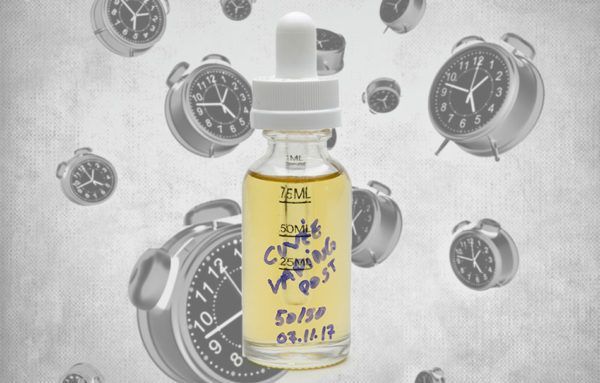 e-juice bottle with clocks in the background