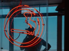 The Tobacco Age In Florida Is Now 21 cigarette logo with a man smoking in the background