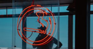 cigarette logo with a man smoking in the background