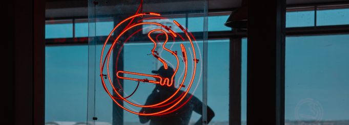 cigarette logo with a man smoking in the background