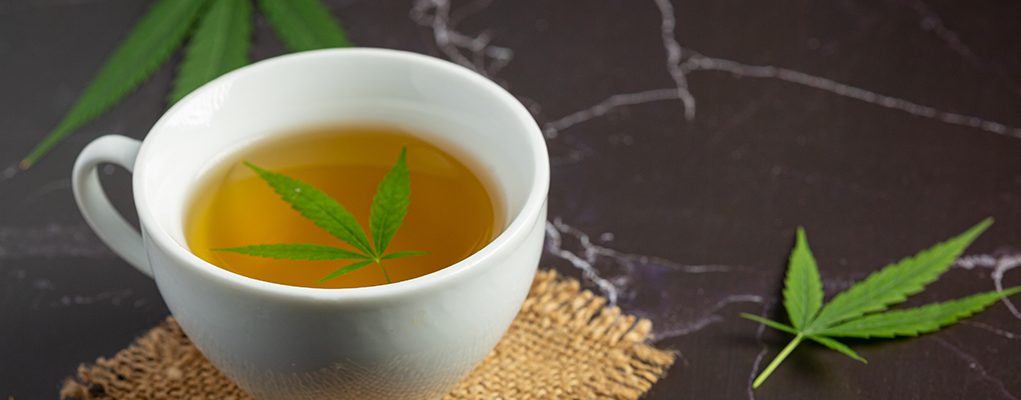 cup of hemp tea with hemp leaf