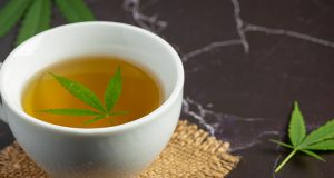 cup of hemp tea with hemp leaf