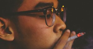young man smoking a cigarette