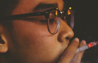 young man smoking a cigarette
