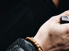 man holding a Juul e-cig