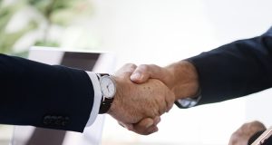 business man shaking hands together