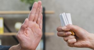 man refusing bunch of cigarettes