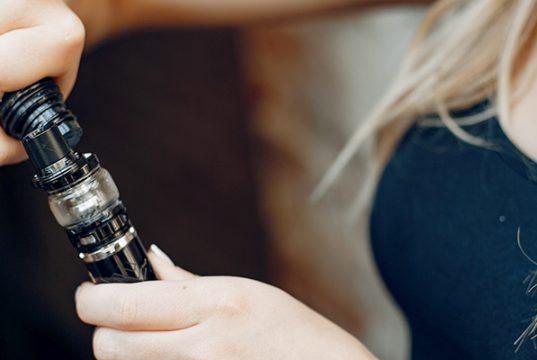 woman filling her vape