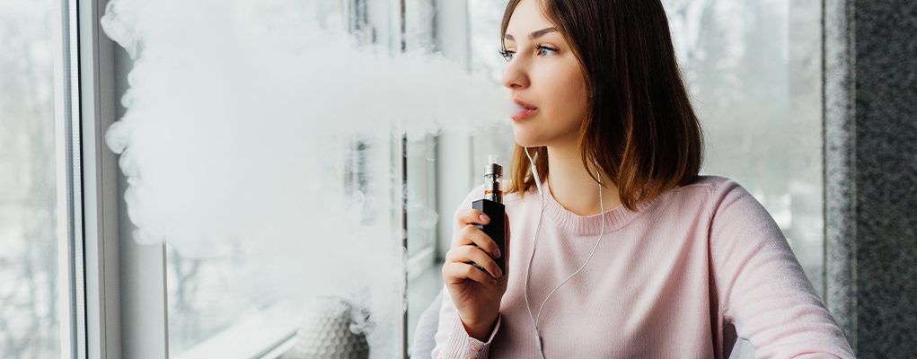 woman vaping while listening music