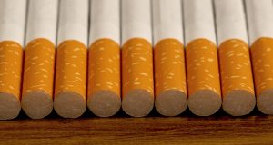 Many cigarettes stacked on wooden floor