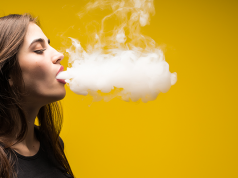 Young woman vaping
