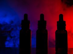 Fluid for electronic cigarettes with a background of a colored cloud of smoke