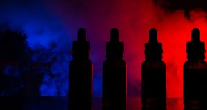 Fluid for electronic cigarettes with a background of a colored cloud of smoke