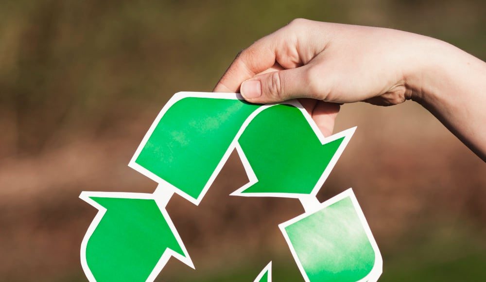 recycle-background-with-woman-holding-recycle-sign اعادة تدوير النفايات الالكترونية