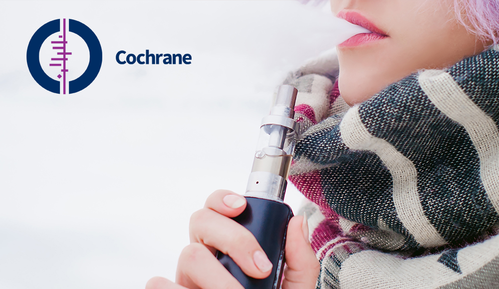 vaping-effective-to-quit-smoking-cochrane-review An e-cigarette next to a tobacco cigarette.